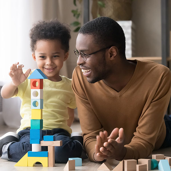 Child and father playing with blocks