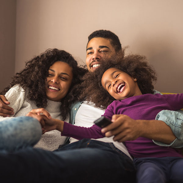 Family laughing on a couch Family laughing on a couch